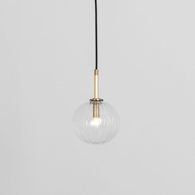 Textured clear glass globe pendant ceiling light with natural brass fixture