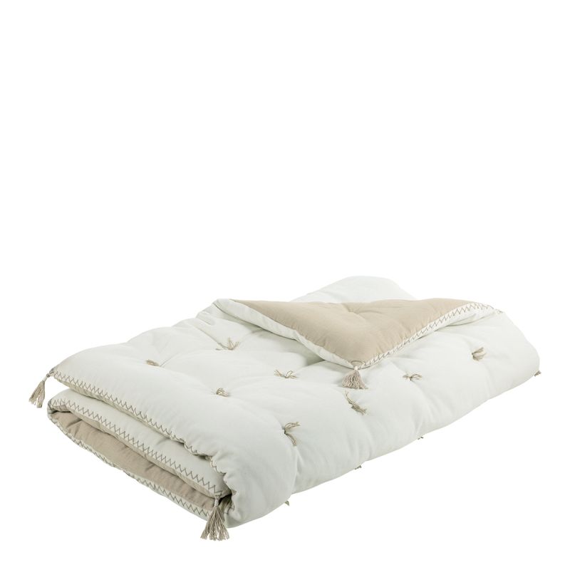 Futon with sand and white colouring and tassels at each corner