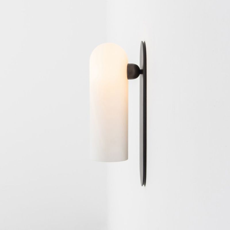 Contemporary solid brass wall lamp in a black gunmetal finish with a long translucent glass lampshade