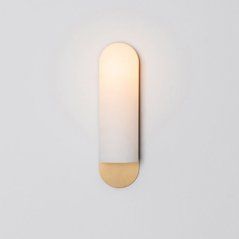 Contemporary solid brass wall lamp in a natural finish with a long translucent glass lampshade