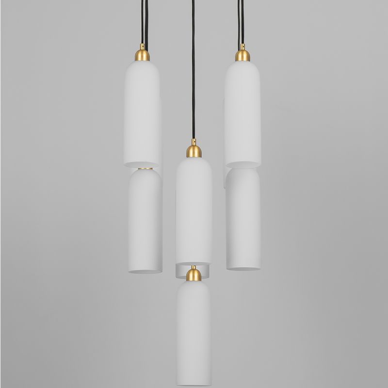 A luxury chandelier by Schwung with 9 frosted, opal glass shades and a stunning solid brass finish 