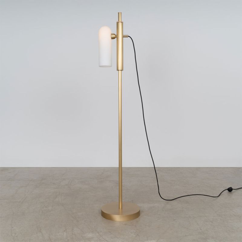 A glamorous industrial lacquered burnished brass floor lamp