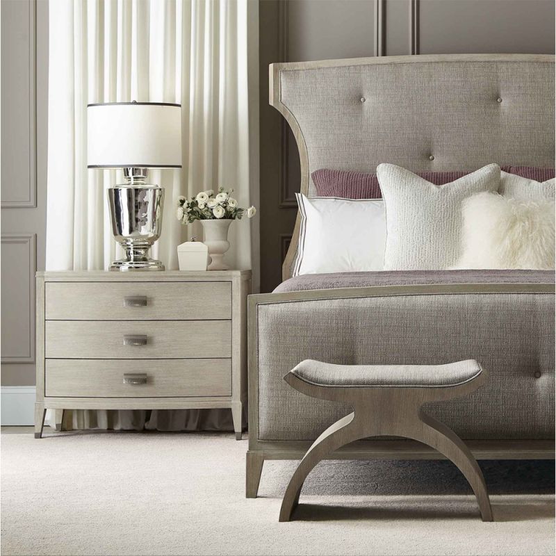 A chic minimal natural wood bedside table with tarnished nickel accents