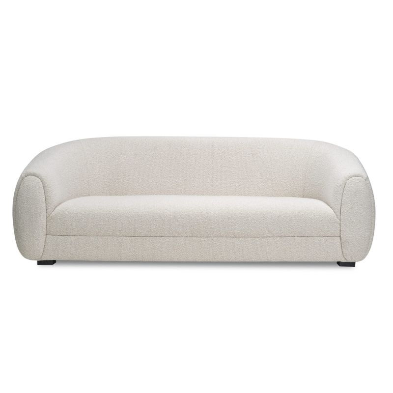 A contemporary sofa by Liang & Eimil with a luxury boucle sand upholstery and curved design