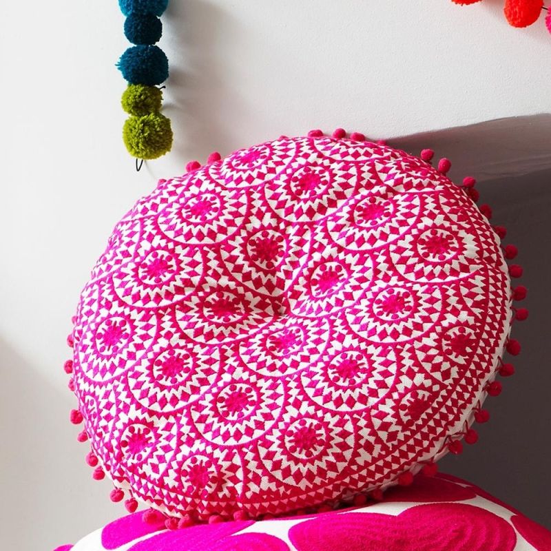 Round embroidered fuschia bohemian patterned cushion