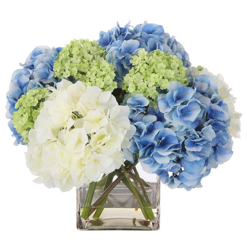 Bouquet of blue, green and white hydrangea in clear glass pot