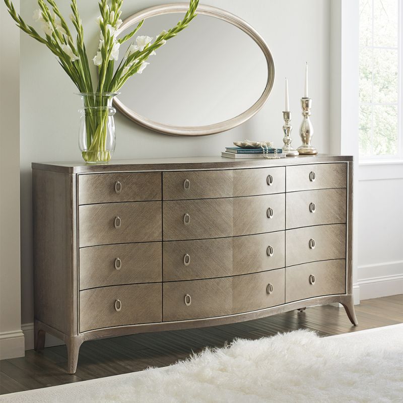 A sophisticated dresser by Caracole with contemporary curves and twelve spacious drawers