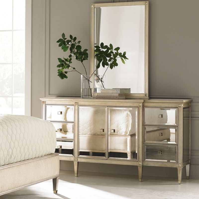 A contemporary cabinet by Caracole with a mirrored design and champagne finish