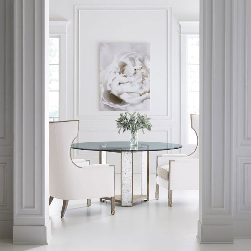 Glamorous round dining table with a glass top and divine crystal-like legs and brass accents
