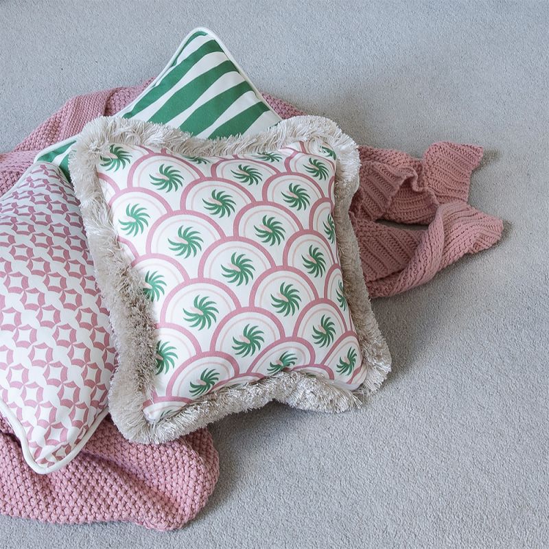 A breathtakingly beautiful children's cushion with a green and pink pattern finished with fringing 