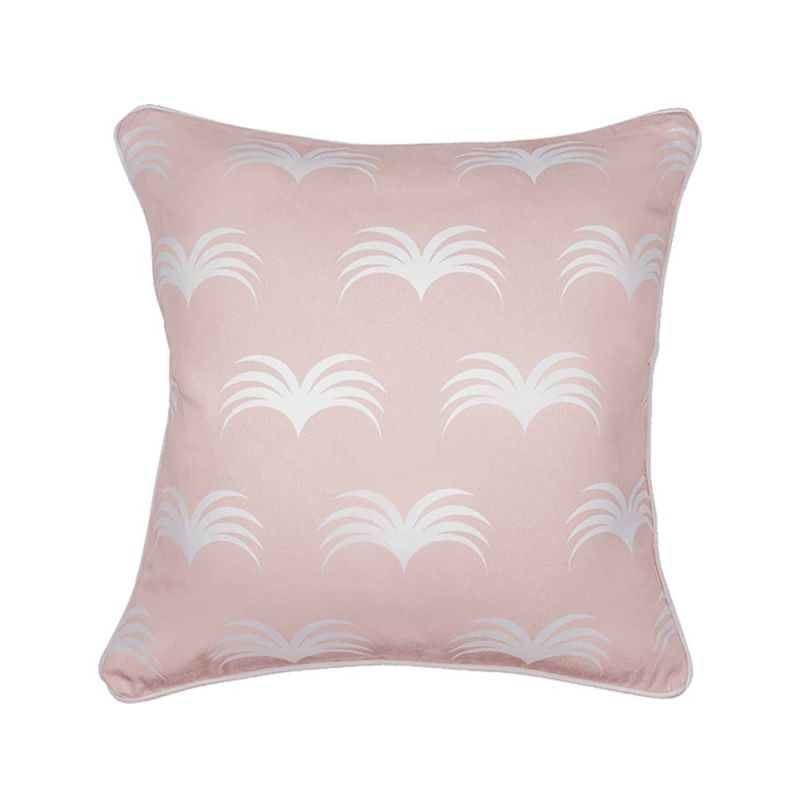 A cute pastel pink cushion with white piping and leaf-like design