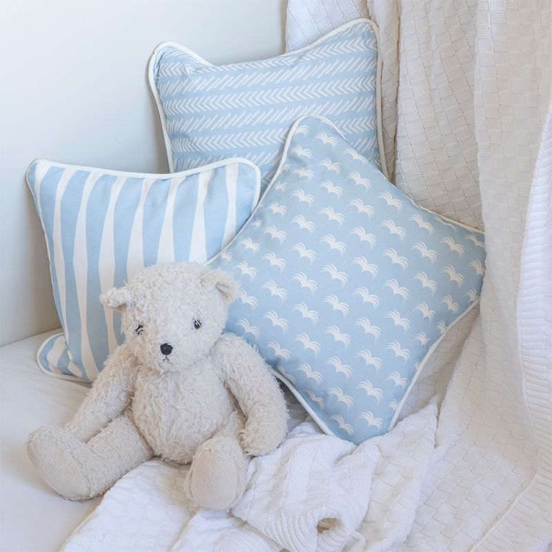 A lovely light blue children's cushion with a fun and playful pattern finished with white piping