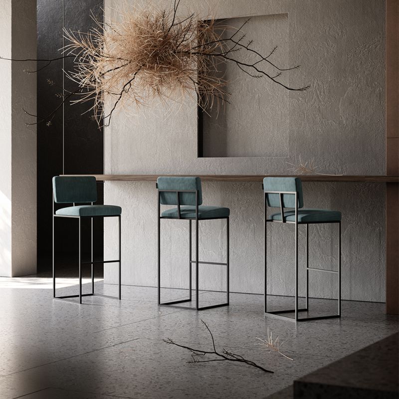 A chic, modern bar stool with a minimal black metal frame and velvet upholstery 