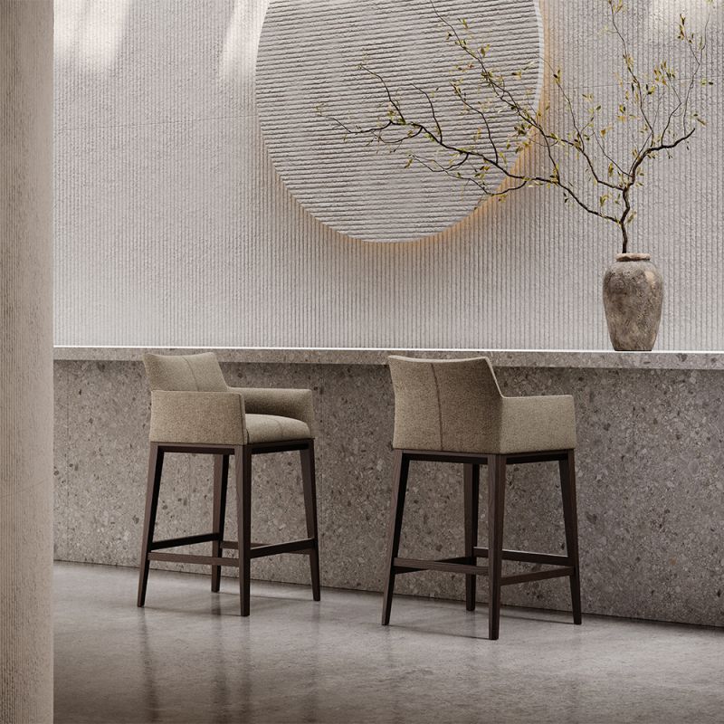 A sophisticated bar stool by Domkapa with a luxury upholstery and solid wood structure