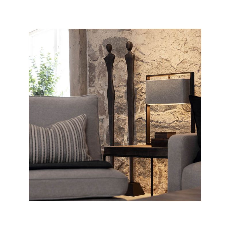 Sleek metal sculpture of a human-like silhouette, in black finish. Floor standing size