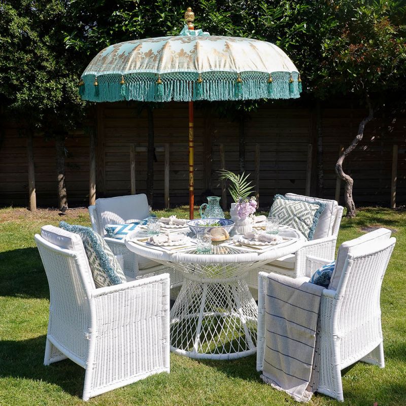White rattan dining table with glass top