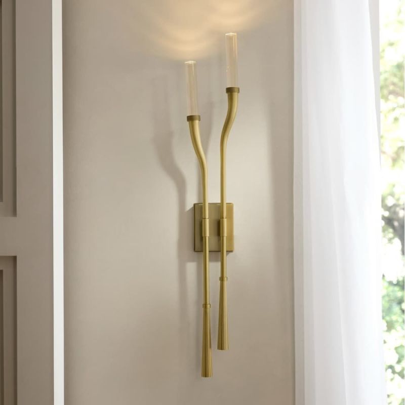 Illuminate your space with the Italo Wall Sconce, featuring a sleek design and warm glow that enhances any decor. Perfect for stylish accent lighting!