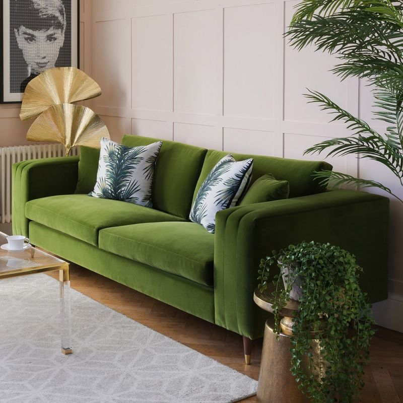 Unique green velvet sofa with fluted oversized arms and gold capped feet