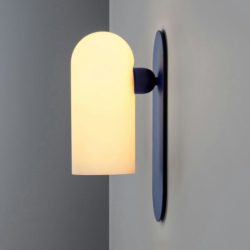 Sculpted wall sconce with a deep blue fixture and a frosted glass shade