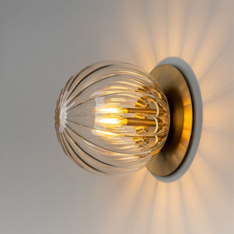 Wall sconce with spherical crystal like shade