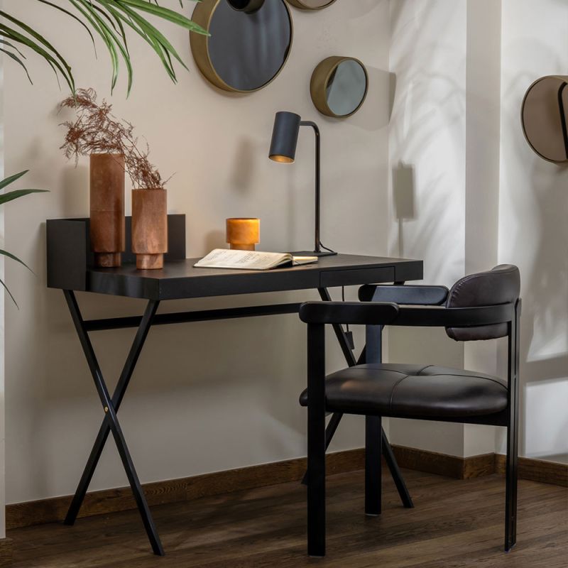 Black sculptural desk with metal legs and wooden table top