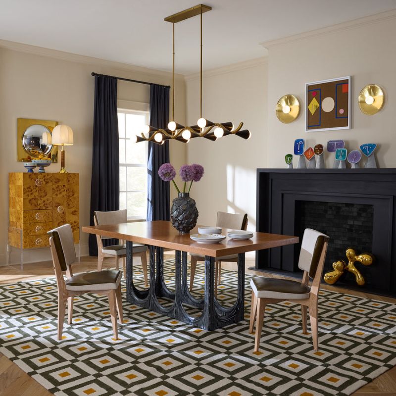 The Coliseum Dining Table features a cork table top supported by ebonized oak arches, blending modern design with organic materials and seating up to eight.