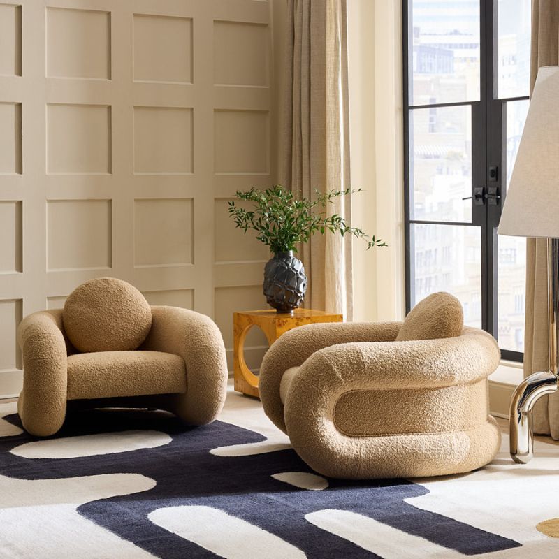 The Pompidou Lounge Chair is a deep, cozy cocoon with a tubular framework, upholstered in Valais Latte bouclé for ultimate comfort.