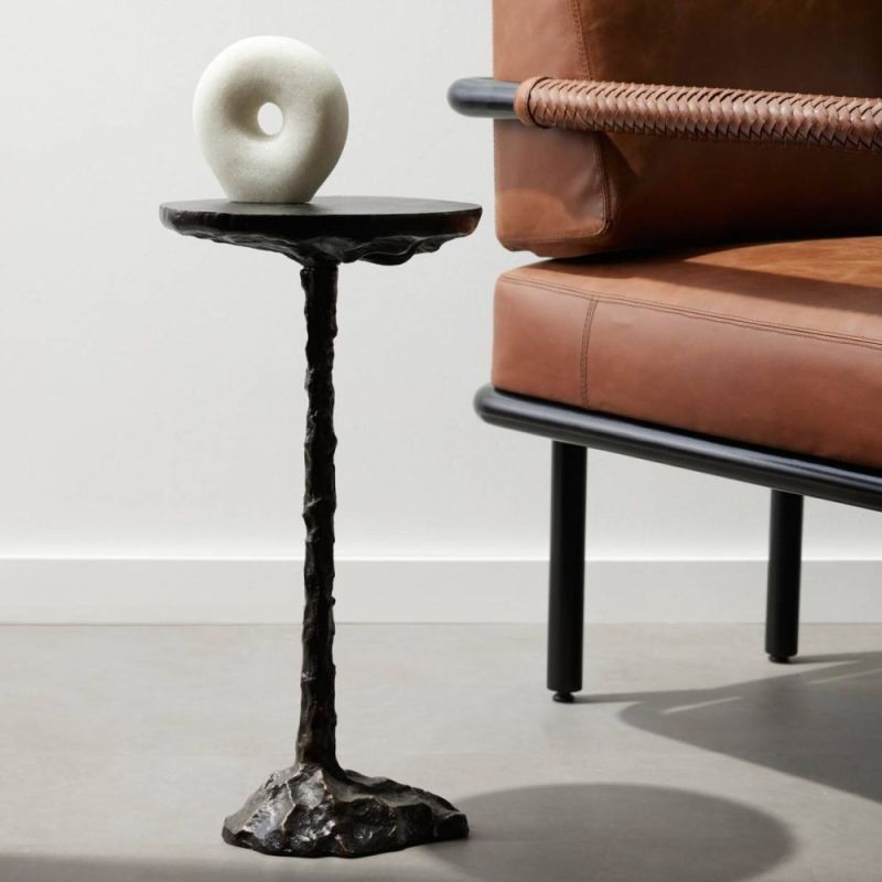 Sculptural black drinks table with cylindrical top