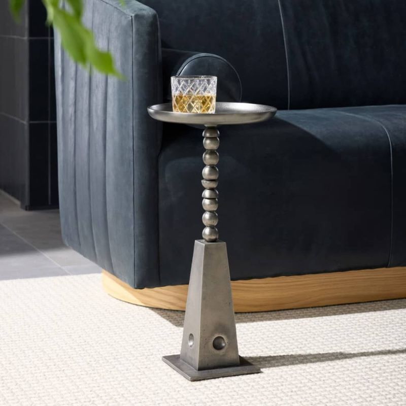 Side table in vintage nickel finish with playful totemic base and circular tabletop