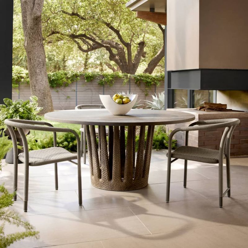 Circular outdoor dining table with tapered crown base