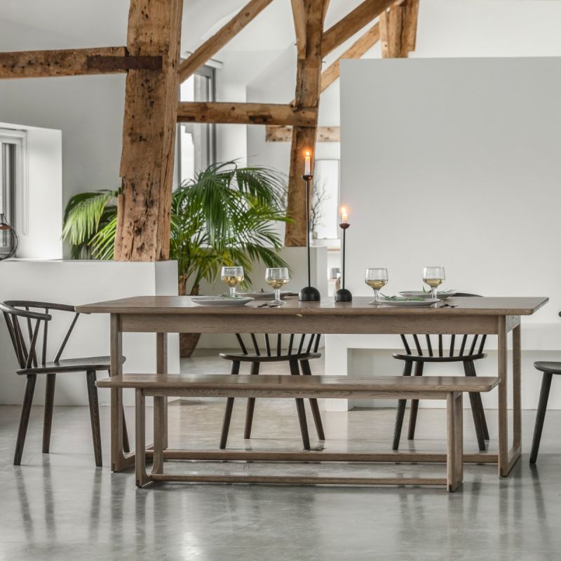 Wooden dining table with shaped underframe