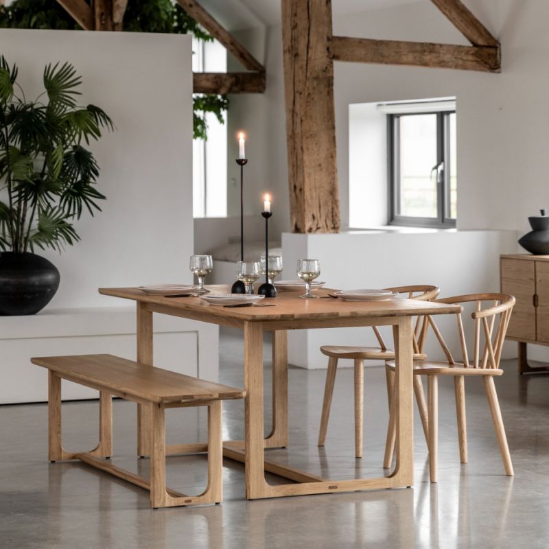 Wooden dining table with shaped underframe