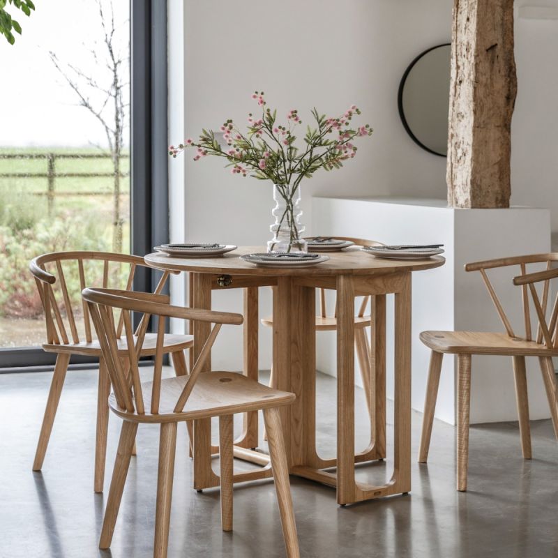 Folding circular wooden dining table with shaped underframe