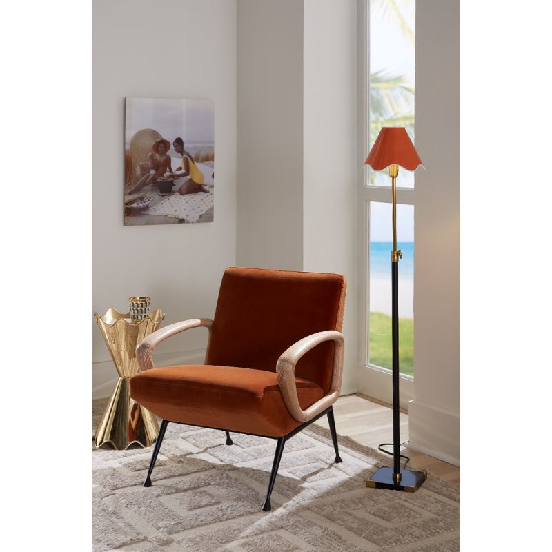 Orange velvet chair with black metal legs and wooden arms