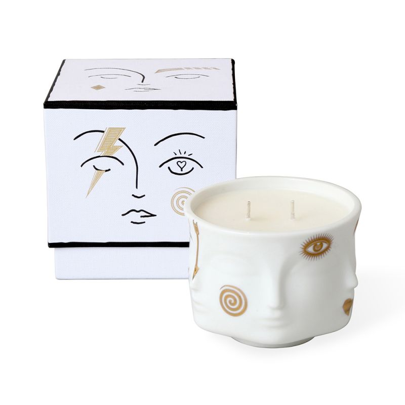 two wick candle in a holder with faces and gold painted details. Scents of grapefruit, raspberry and rose petal