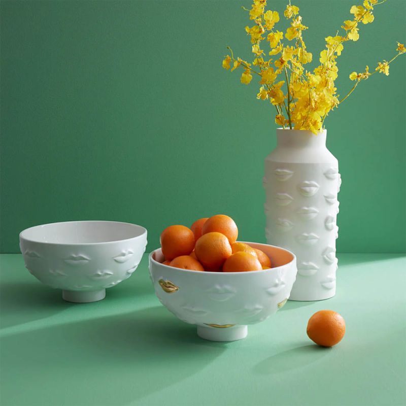 White bowl with lips detail and gold accents
