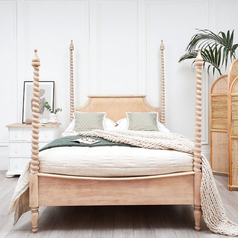 A luxurious acacia and cane 4 poster bed with a rattan headboard