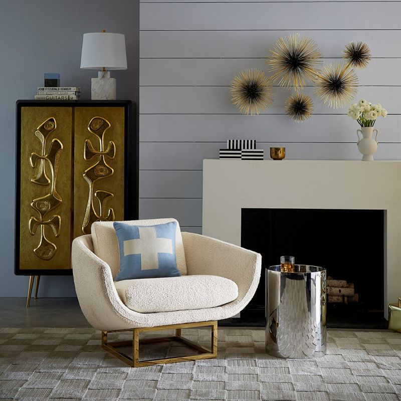 modern luxe armchair with ivory boucle upholstery and polished brass base