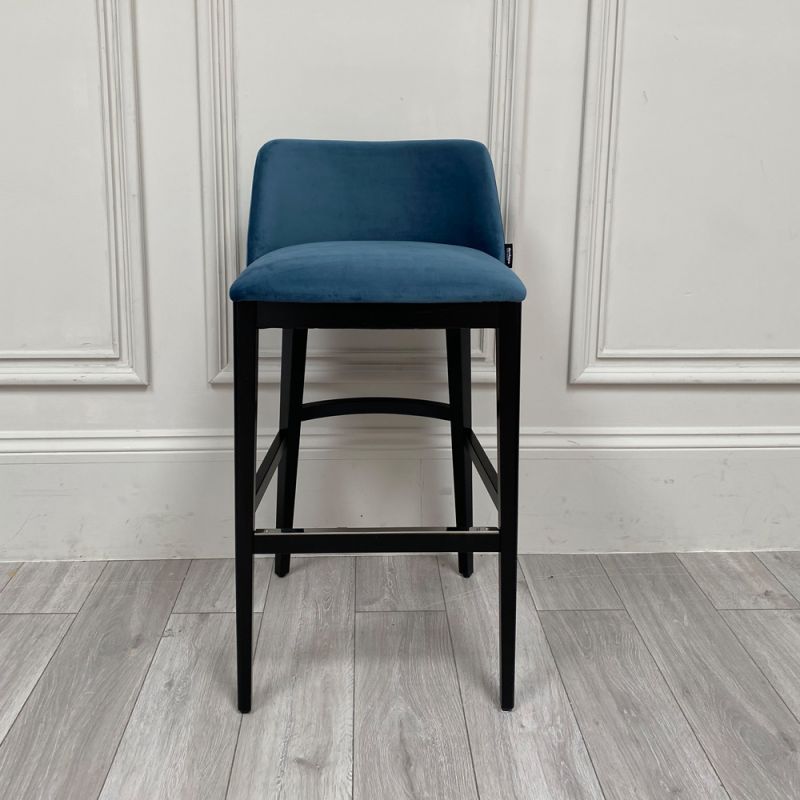 A luxurious dark blue velvet designer bar stool