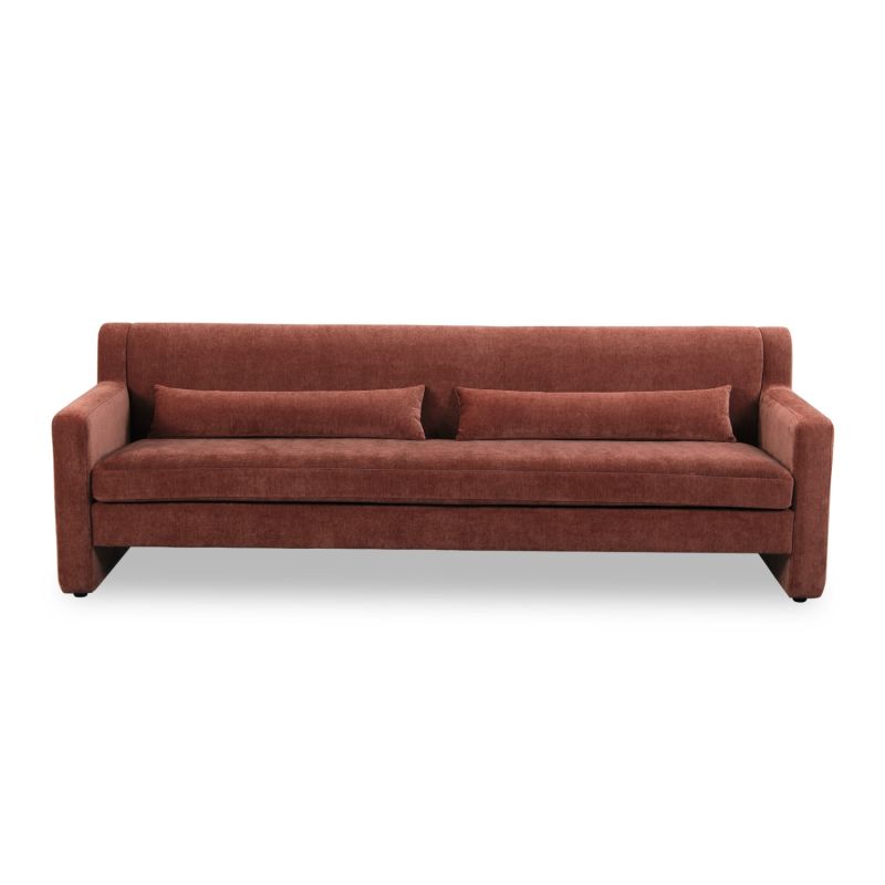 A modern sofa with a statement rust upholstery and scatter cushions