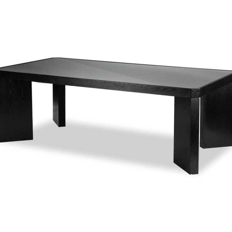 Wide legged dining table in black wood finish with glass top