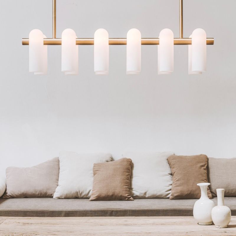 Contemporary natural brass finish chandelier with a colonnade of translucent glass lampshades 