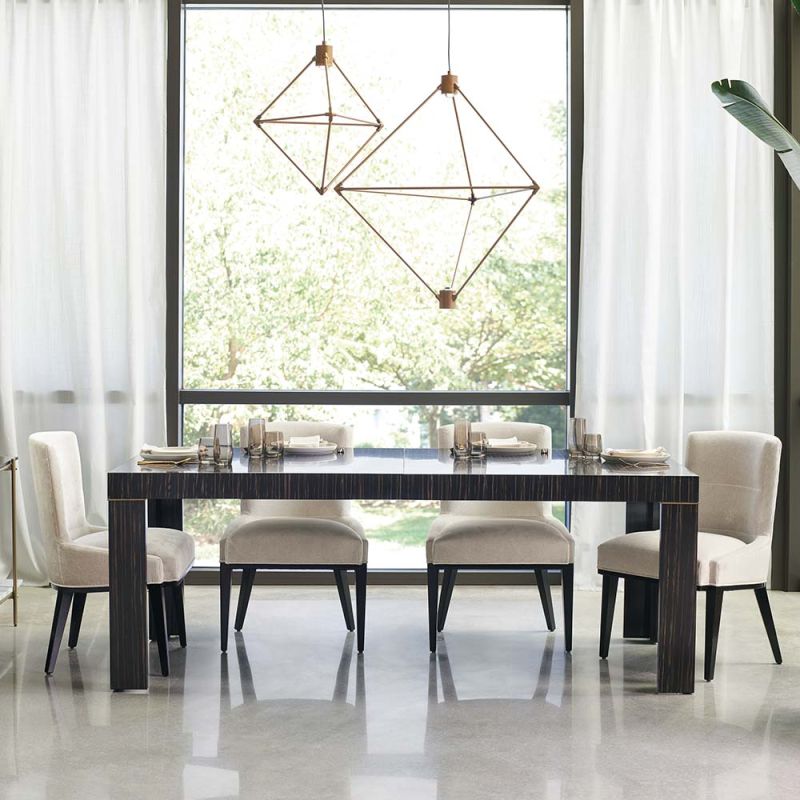 A luxurious extendable ebony dining table with painted metallic bronze details