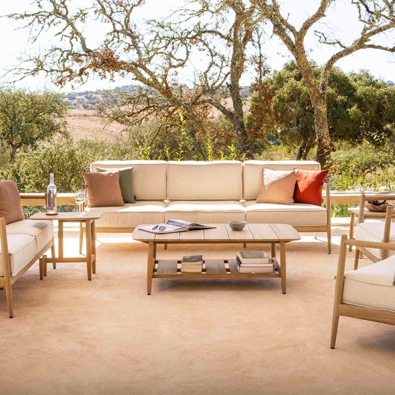 Cosy three-seater outdoor sofa with plush, bespoke upholstered seat and back cushions