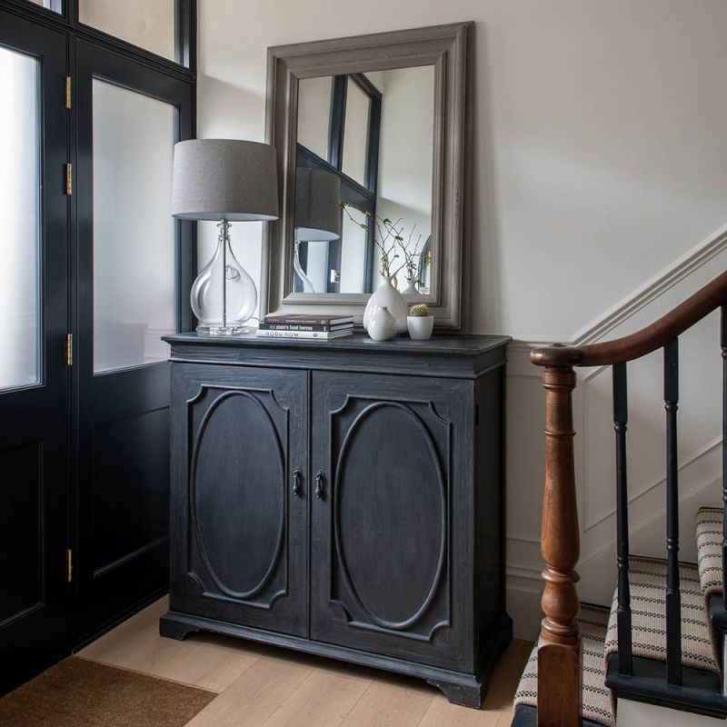 Bold black cabinet with statement panelling on the doors