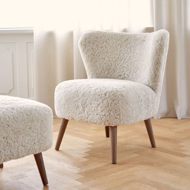 Gorgeously soft sheepskin chair with elegantly tapered walnut wood legs 