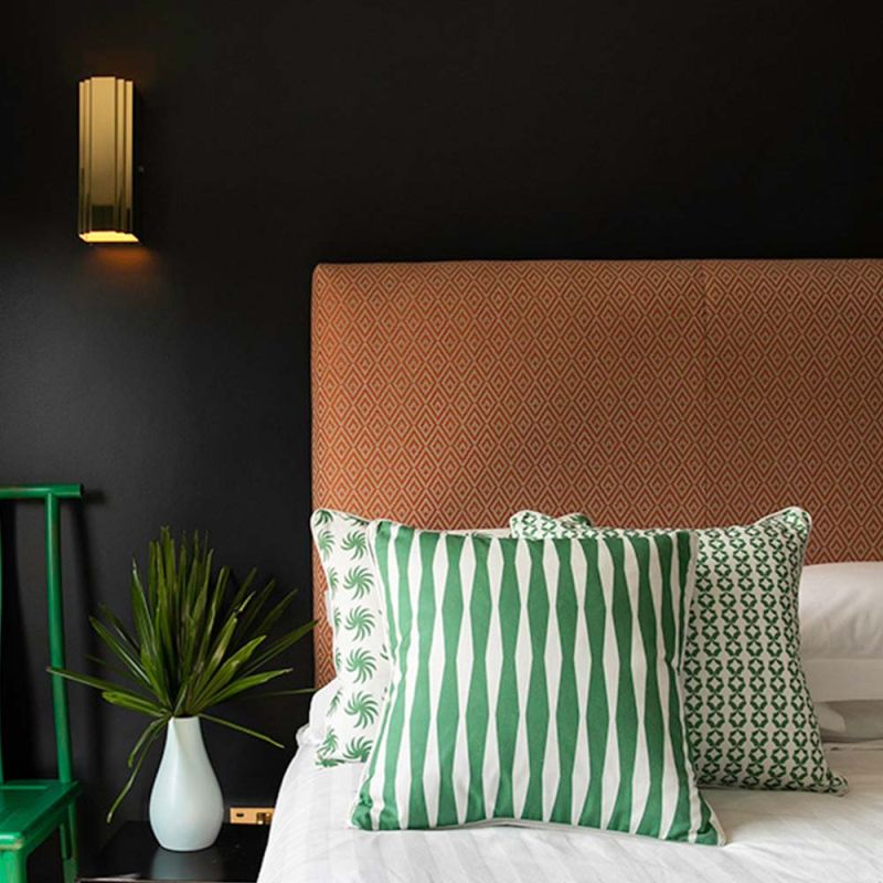 A gorgeous green and white, diamond striped cushion