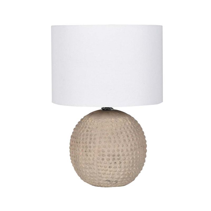 A gorgeous table lamp with a round, neutral and textured base with a white linen shade