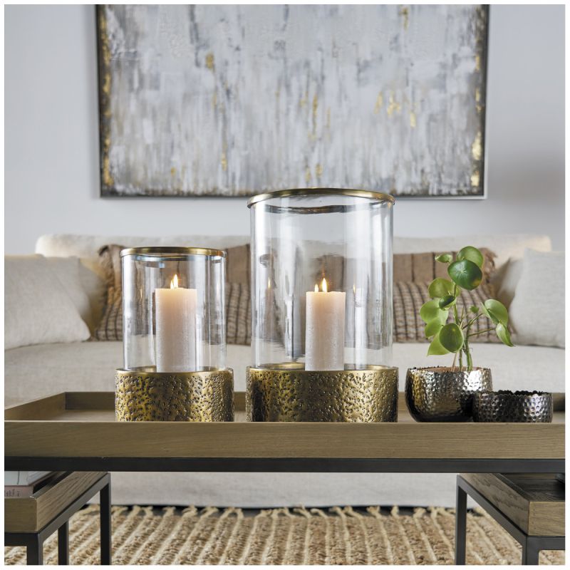 Lantern with textured brass base and cylindrical glass frame