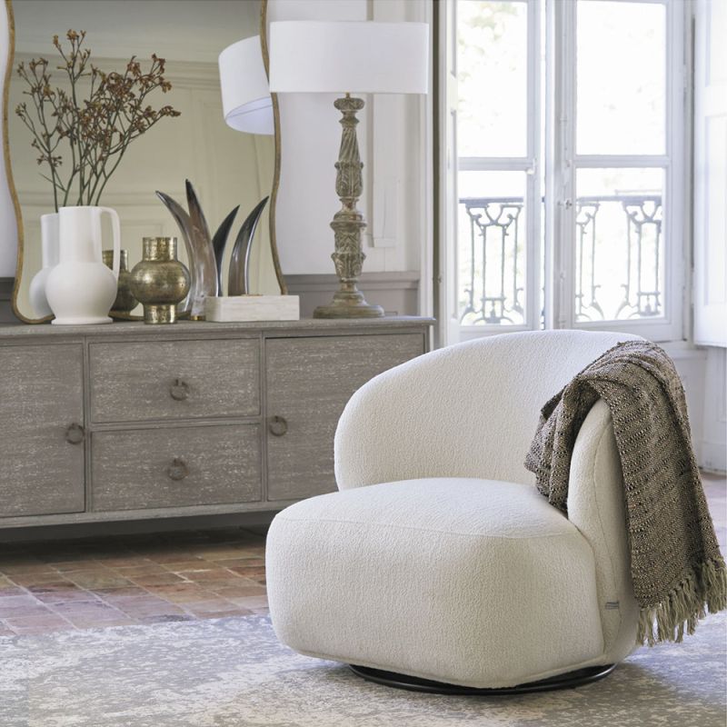 A luxurious armchair with a sumptuous upholstery and stylish swivel base